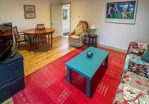 a living room with a couch and a table at THE ASH TREE - Charming & comfortable apartment in Frome