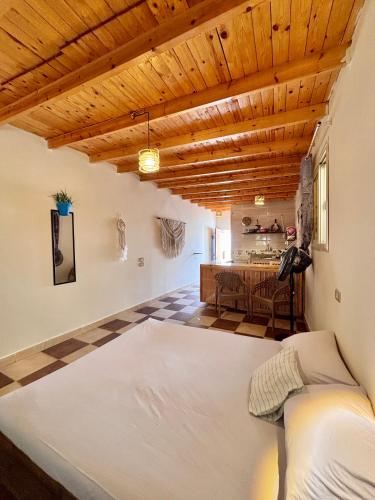 a bedroom with a bed and a dining room at Mashrum House in Dahab