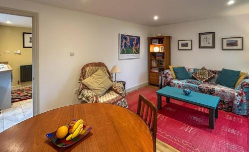 a living room with a table and a couch at THE ASH TREE - Charming & comfortable apartment in Frome