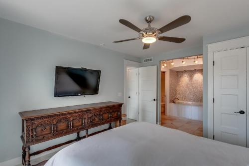 a bedroom with a bed and a ceiling fan at BEST BEACH Cottage Two Gorgeous Ocean Views - Renovated Like POTTERY BARN - Beach Steps Away in Saint Augustine Beach
