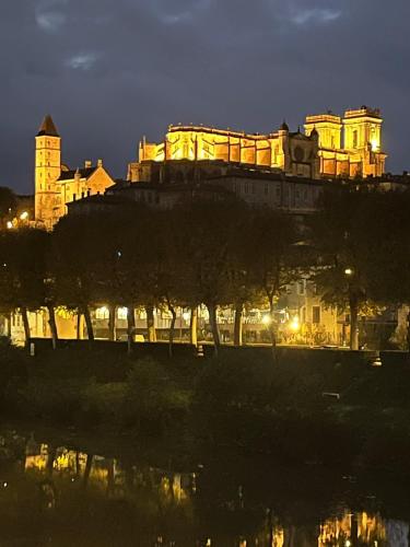 a castle on top of a hill at night at Les vallons de Gascogne in Bazian