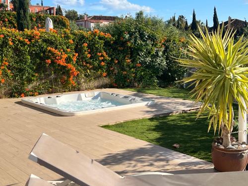 a hot tub in the middle of a garden at Casa Carolina - This One in Higuerón with Quality and Peace in Mijas
