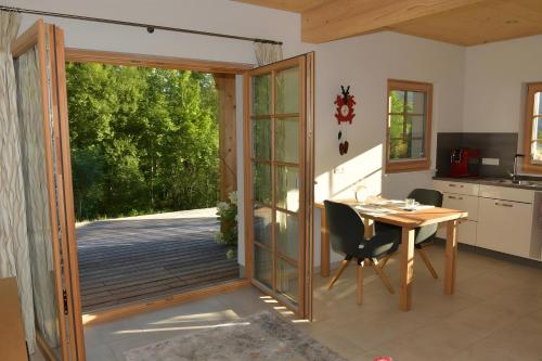 a kitchen and dining room with a sliding glass door at Ferienwohnung am Nettenbach in Bernau im Schwarzwald