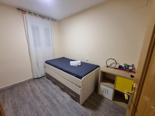 a small room with a bed and a desk at VUT EL Mogollón in Guadalajara