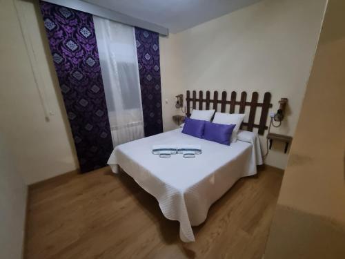 a bedroom with a bed with two glasses on it at VUT EL Mogollón in Guadalajara