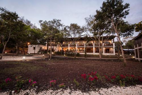a large building with a garden in front of it at Pacaya Lodge and Spa in La Laguna