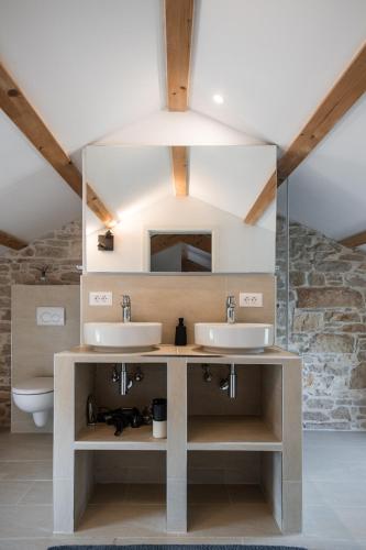 a bathroom with two sinks and a mirror at Villa Verde Višnjan in Višnjan