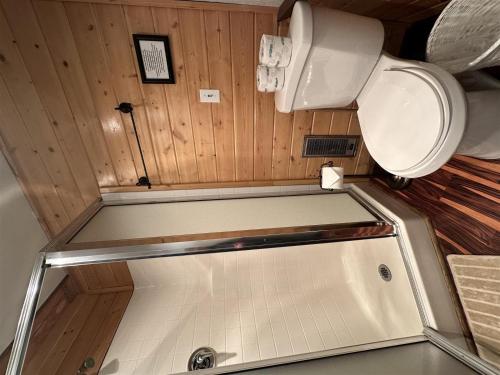 a small bathroom with a toilet and a tub at Culps Cascade | Wi-Fi, Woodstove, Cedar Hot tub in Packwood