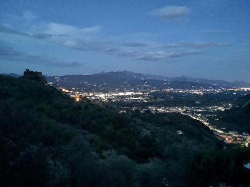 a view of a city from a hill at night at Trebiano a casa dei nonni in Arcola