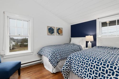 a bedroom with two beds and a window at Capacious North Truro Beachfront Home in Provincetown