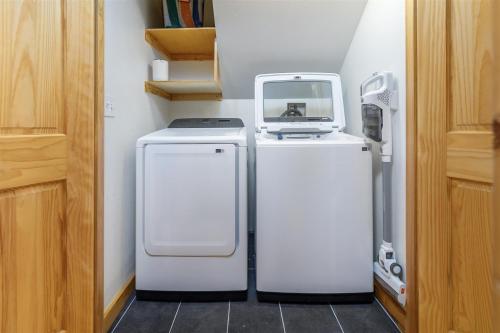 a small refrigerator with a microwave on top of it at Alpine Drift in Packwood