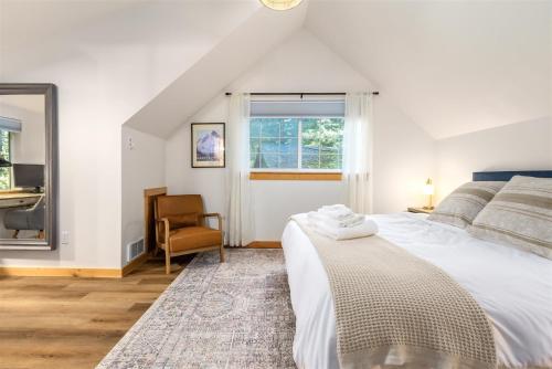 a bedroom with a bed and a chair and a window at Alpine Drift in Packwood