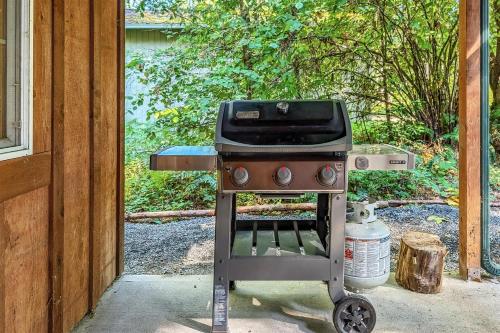 a grill is sitting outside of a house at Alpine Drift in Packwood