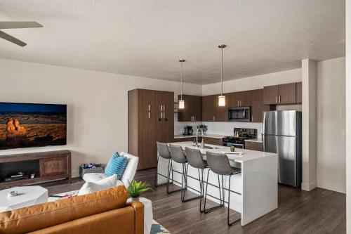 a kitchen and living room with a couch and a table at Stunning 1BD Pool, Htub, Gym Near Convention Centre in Salt Lake City
