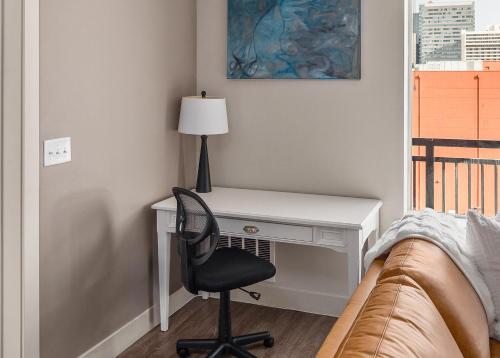 a bedroom with a desk and a chair next to a bed at Stunning 1BD Pool, Htub, Gym Near Convention Centre in Salt Lake City