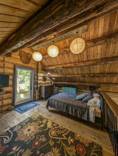 a bedroom with a bed in a log cabin at Elkhorn Lodge | Wifi, Pet Friendly, AC in Packwood