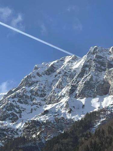a mountain with snow on it with an airplane at Eisenerz Alpine Apartement RoSy in Eisenerz