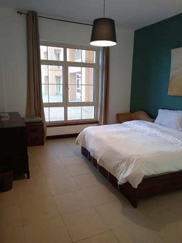 En eller flere senge i et værelse på درة أبراج المارينا Dora Al marina