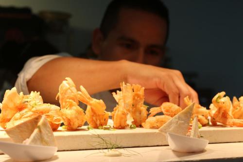 a man sitting at a table with a plate of food at Xeliter Balcones del Atlantico - Las Terrenas in Las Terrenas