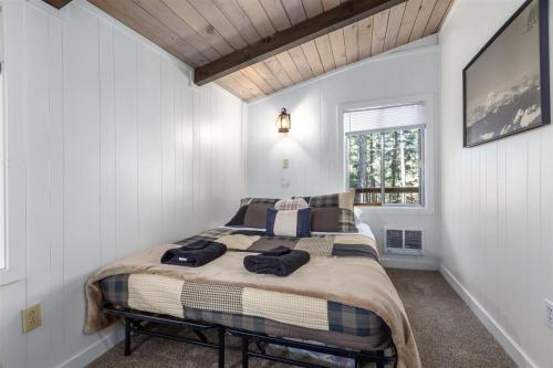 a bedroom with a bed in a white room at Glacier Peak Getaway | Wifi, Fireplace, Lower Timb in Packwood