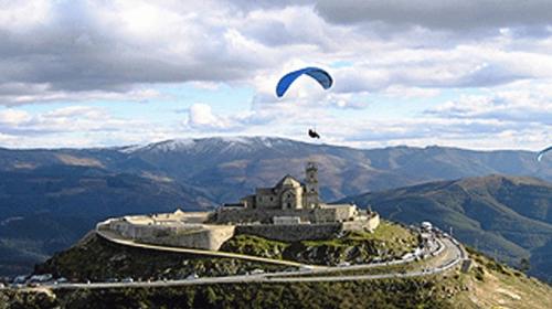 a kite flying over a building on top of a mountain at CASA TAPADA DA CHEDA 2 in Celorico de Basto