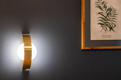 une lumière sur un mur à côté d'une photo dans l'établissement Appartement Central Lyon 3ème, à Lyon