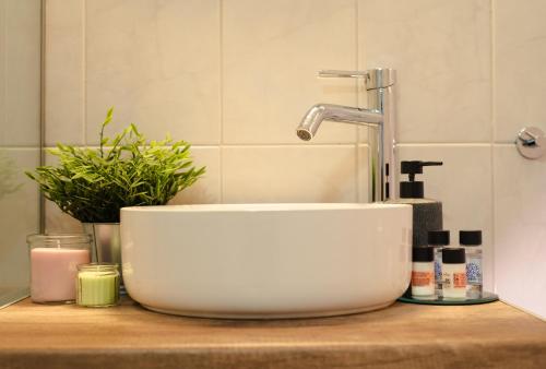 a white sink on a counter in a bathroom at Central House in Plaka in Athens