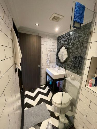 a bathroom with a toilet and a sink at Eleanor Homes in Jomtien Beach