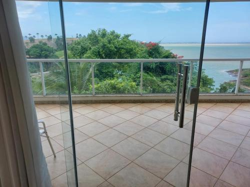 a room with a view of the ocean from a balcony at Casa Nascer do Sol- Iriri-ES in Anchieta