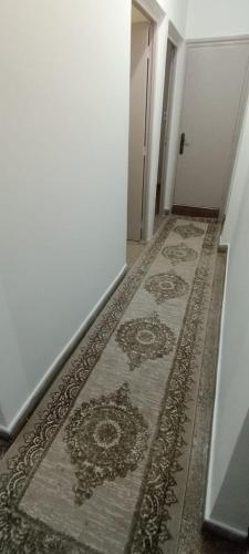 a hallway with a patterned rug on the floor at Maison pres plus Grand Bazar d'Afrique Souk El Had in Agadir
