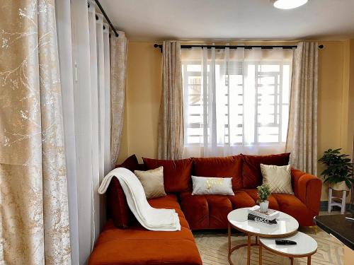 a living room with a red couch and a table at Bella Homes 2br Thika Town in Thika