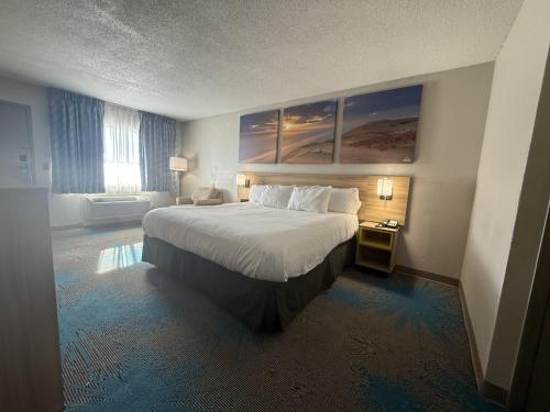a hotel room with a large bed and a window at Days Inn by Wyndham Hannibal in Hannibal