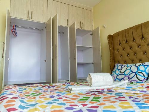 a bedroom with a bed with a colorful comforter at Executive 1 bedroom house in Nairobi