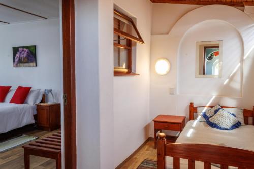 a small bedroom with a bed and a table at Haus Garnison B&B in Swakopmund