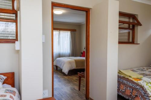 a mirror in a room with a bedroom at Haus Garnison B&B in Swakopmund