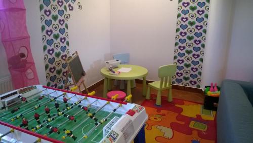 a toy room with a table and a soccer ball at Apartamenty Lawenda in Rabka