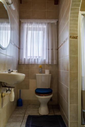 a bathroom with a toilet and a sink at Haus Garnison B&B in Swakopmund