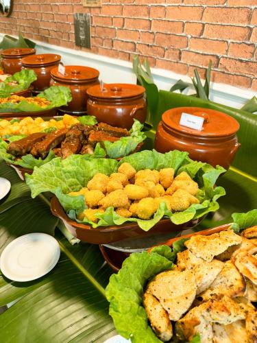 a buffet filled with different types of food on a table at ATH Hotel - Américas Townhouse in Rio de Janeiro