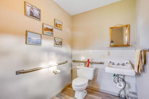 a bathroom with a toilet and a sink at Michigan Manistee River Cabin about 1 Mi to Downtown in Manistee