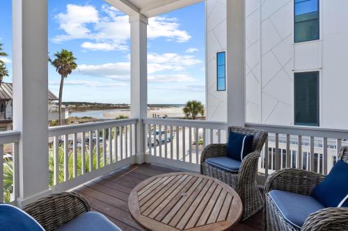 a porch with chairs and a table and a view of the beach at Grayt Digs by AvantStay Next to Beach Oceanview in Santa Rosa Beach