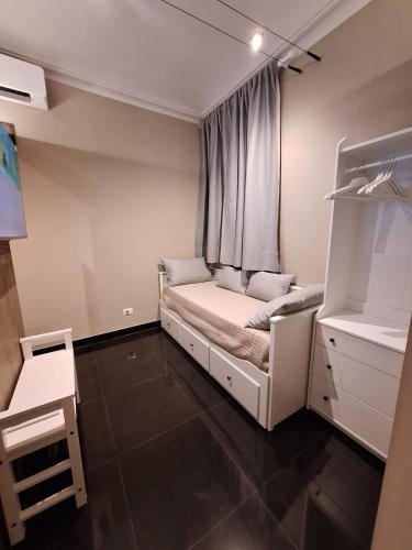 a small bedroom with a bed and a window at Smarthome Suites Centro Storico Collegno in Collegno