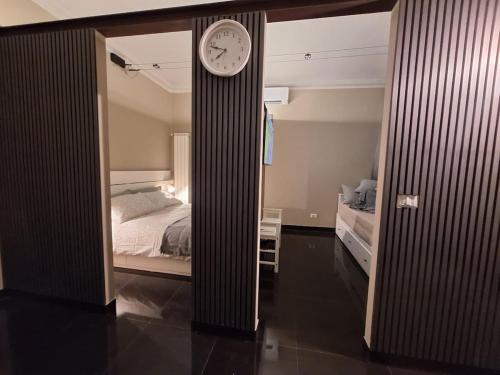 a bedroom with a bed and a clock in a doorway at Smarthome Suites Centro Storico Collegno in Collegno