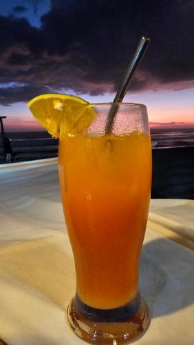 a drink sitting on top of a table at Mano a Mano Eco Hostal in Las Peñitas