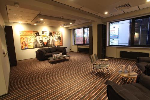 a living room with couches and a large screen at Mercure Kyiv Congress in Kyiv