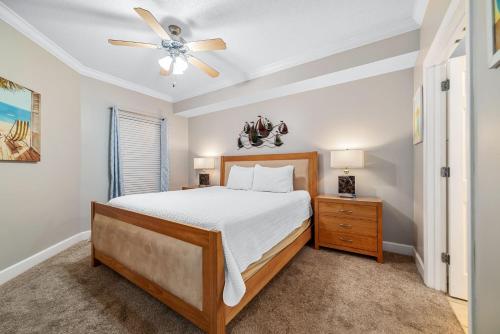 a bedroom with a bed and a ceiling fan at Phoenix on the Bay 1514 in Orange Beach