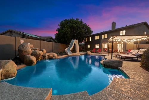 a swimming pool with a slide in a backyard at 5 Bedroom 4 Bath Boutique Home PREMIUM LOCATION + heated pool option in Glendale