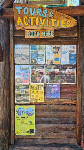 a sign for a tours and activities book store at Mano a Mano Eco Hostal in Las Peñitas