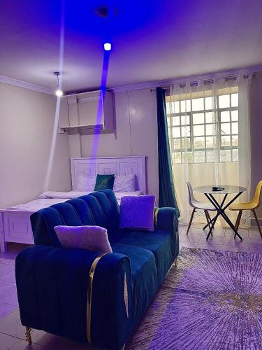 a living room with a couch and a table at Bella Homes Thika Town Studio in Thika
