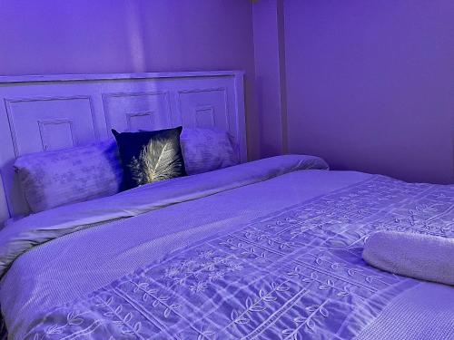 a purple bedroom with two beds with pillows at Bella Homes Thika Town Studio in Thika