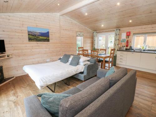 a living room with a couch and a table at Dovestone Luxury Lodges sleeps 6 - pet free in Oldham